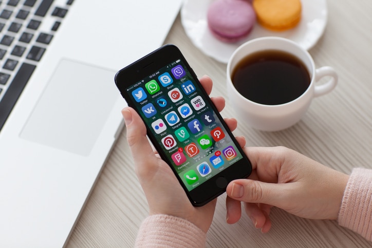 A set of programs from famous brands of social networking on the iPhone 7 in woman hands. iPhone 7 Jet Black was created and developed by the Apple inc.